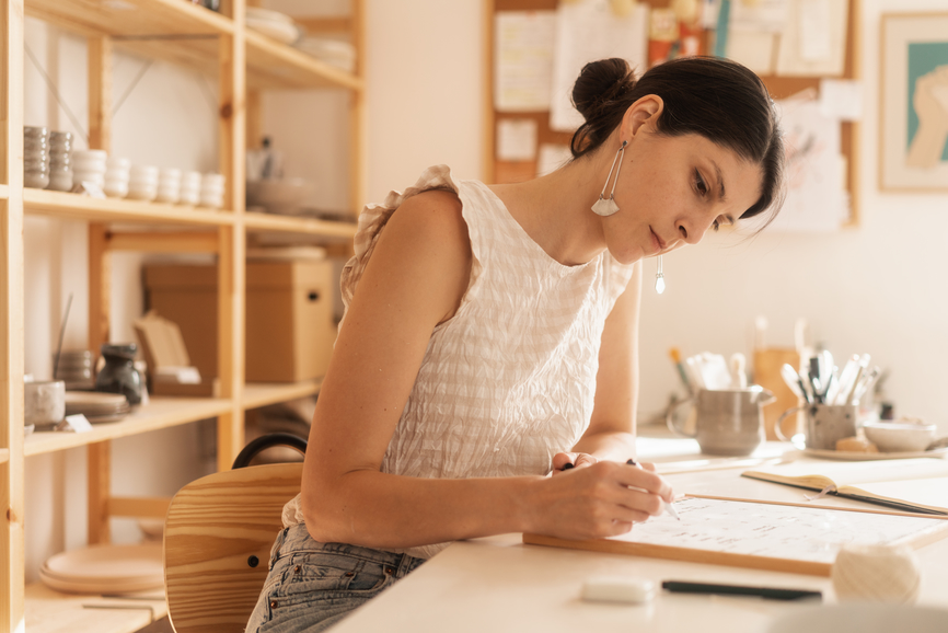 Woman designing online course on a whiteboard