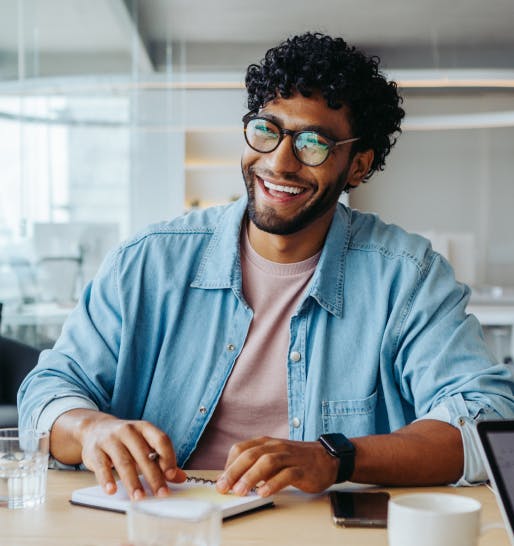 Man laughing and working