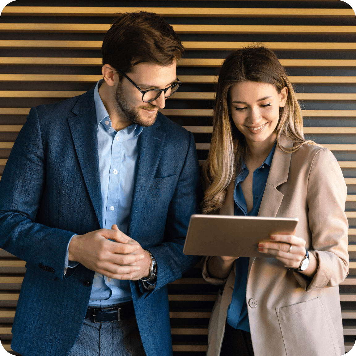 Two people working off a tablet